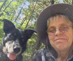 Photo of Susan Rausch with a dog, in the snow